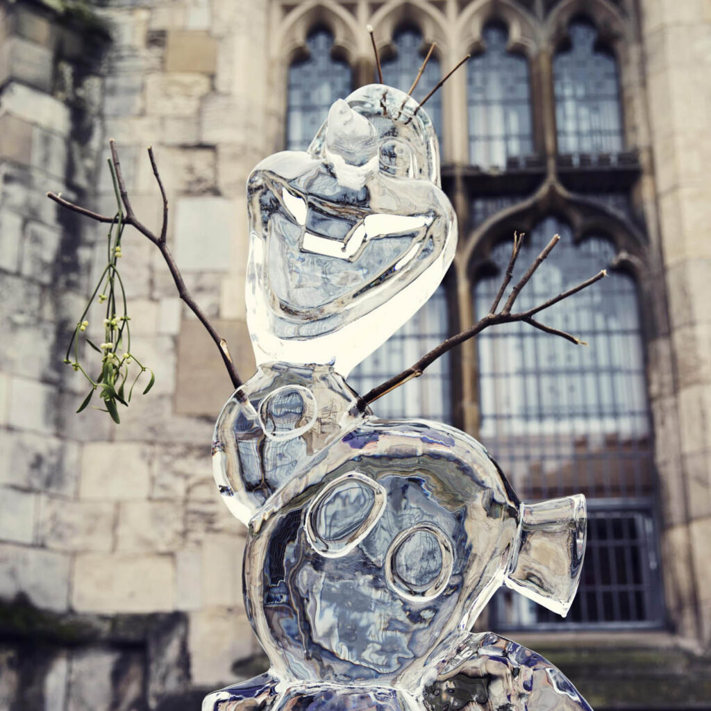 An ice sculpture of Olaf has been placed outside of Darlington's church. His arms are made of sticks and they stretch out in a happy leap. A sprig of mistletoe hangs from one arm.