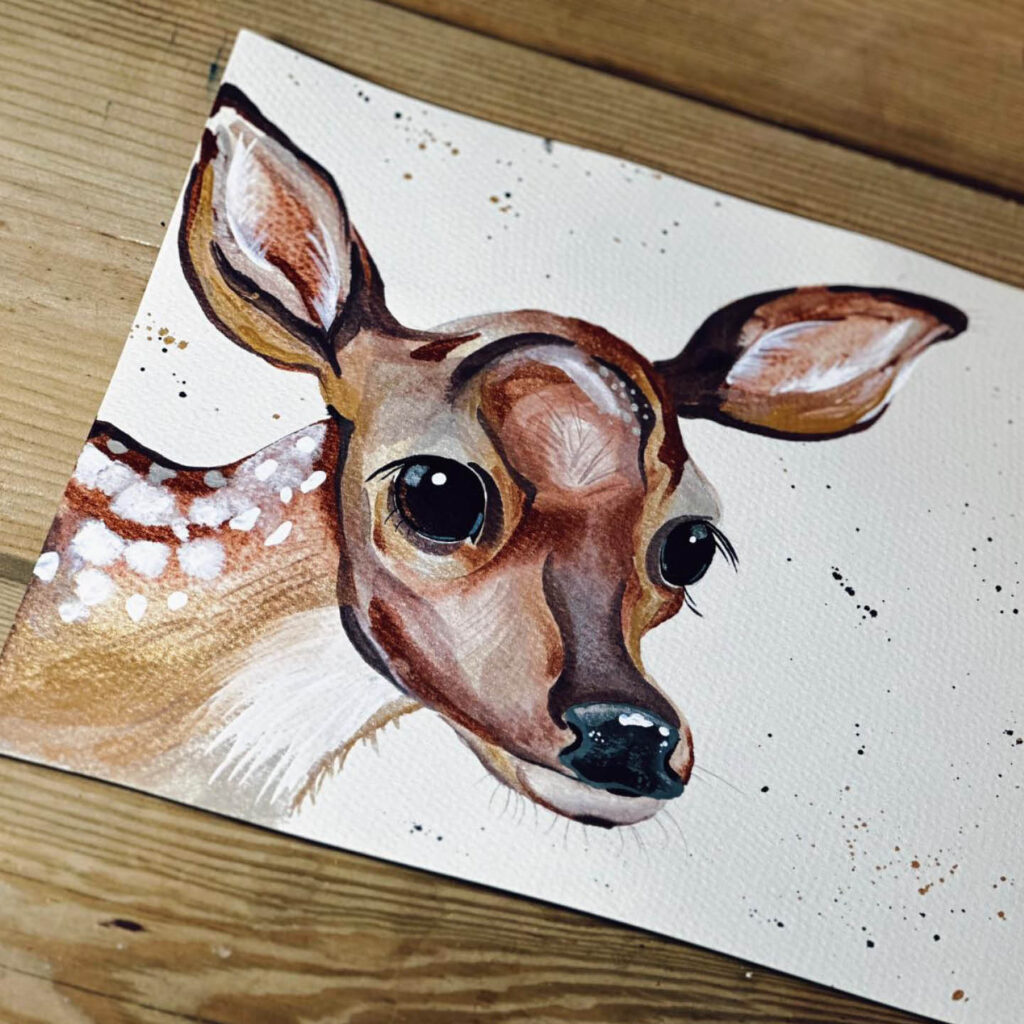 A painting of a cute fallow deer on textured white paper.