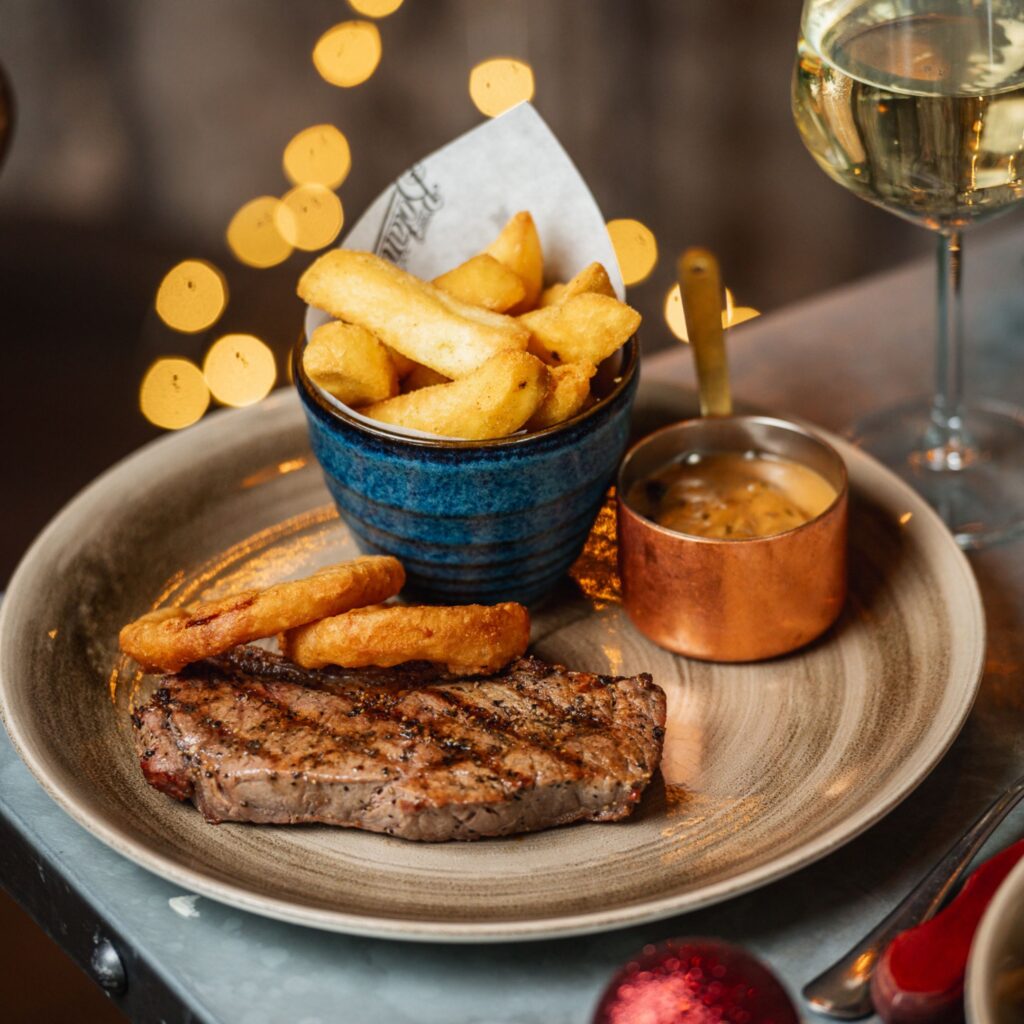 A plate of steak, chips and mushroom stroganoff sauce are beautifully presented for a festive meal out at the Botanist
