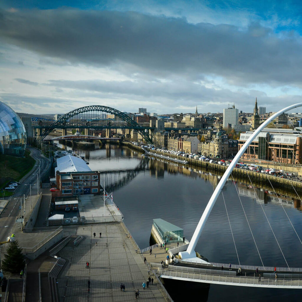 View of Tyne Bridge and Newcastle on a cloudy day.