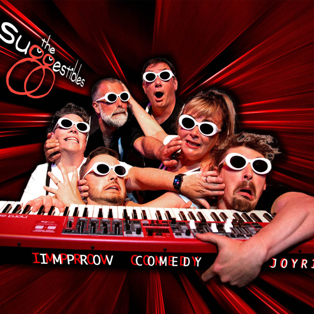Six people wearing matching white sunglasses pull funny faces against a red vortex-style background. They grab onto a red keyboard in front of them, which features the words: Improv Comedy Joyride.