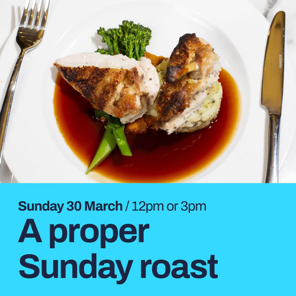 A plate of roast chicken, potato and tenderstem broccoli on a pool of gravy. Below this image, a bright blue strip features the words: A proper Sunday Roast. Sunday 30 March.