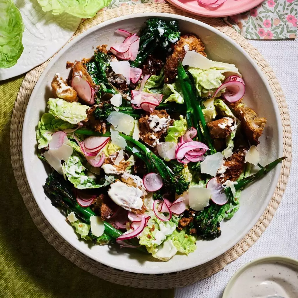 Charred broccoli salad with za’atar croutons, pickled radish and onions