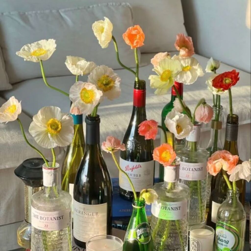 Fresh flowers in wine bottles