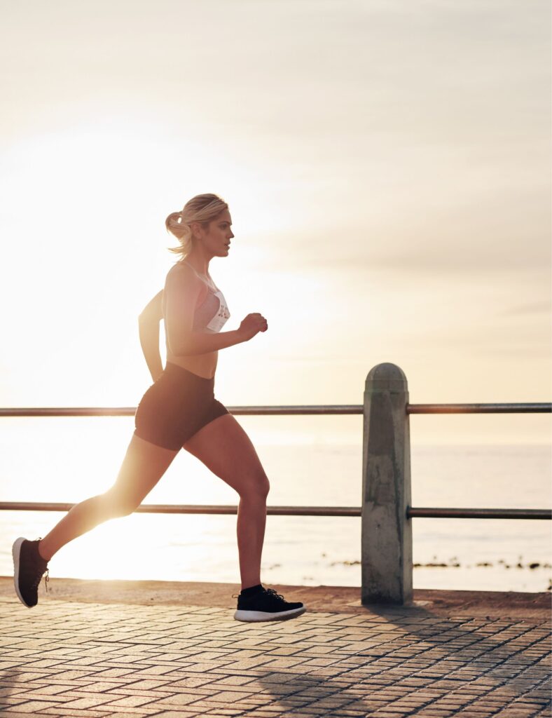 A woman is running along the quayside