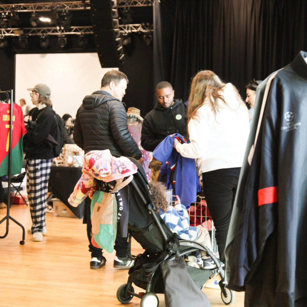 People browse vintage clothes at the 8992 Vintage Market inside Wylam Brewery.
