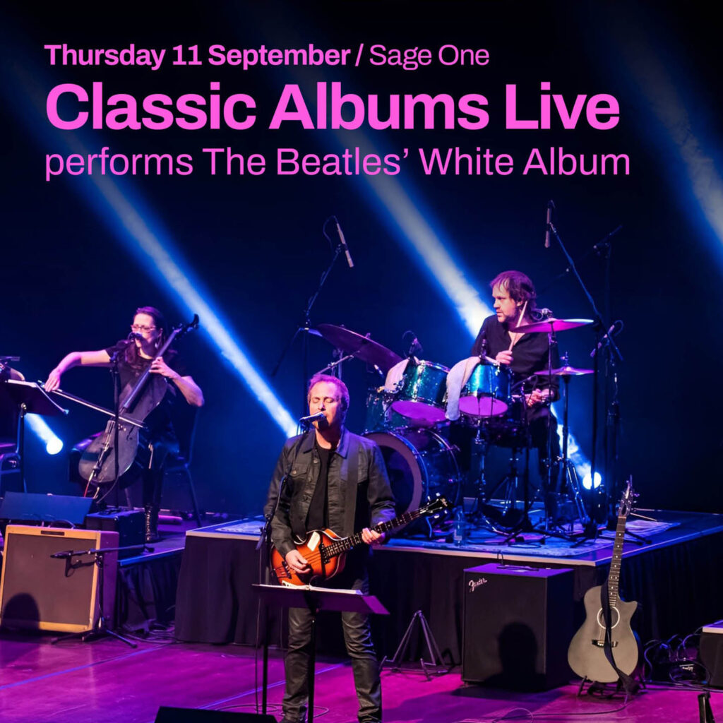 Three men - a singer, a guitarist and a drummer - perform on a strobe lit stage illuminated with purple light. Pink text above them says: Classic Albums Live performs The Beatles White Album.