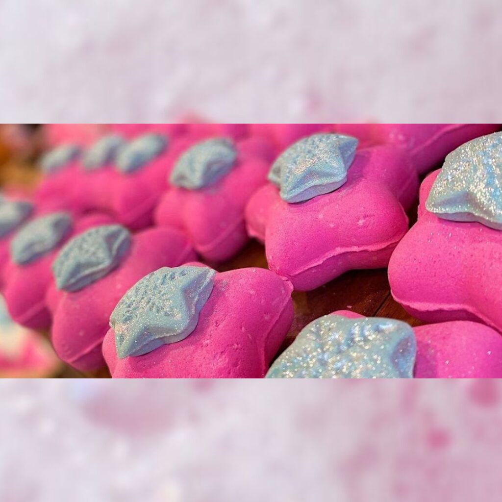 Rows of bright pink bath bombs shaped like stars. Each one is topped with a smaller silver star. This is one of the products guests can try at the Lush Christmas Lock-in in Sunderland.