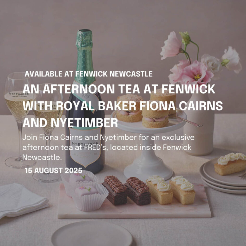 Delicate cakes, sponges and scones are arranged alongside a white vase of pink roses and a bottle of sparkling wine. White text overlays the image. It says: An afternoon tea at Fenwick with royal baker Fiona Cairns and Nyetimber.