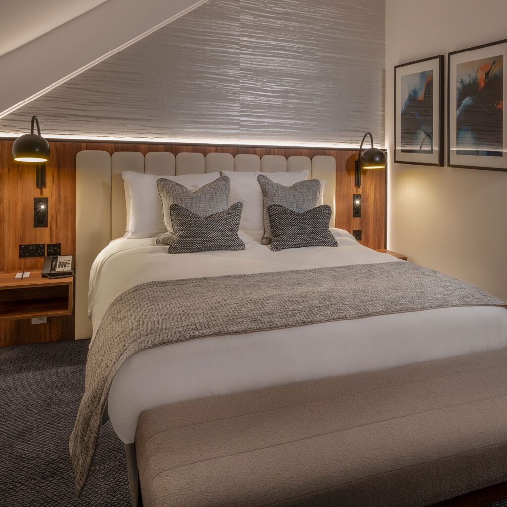 Why Radisson Blu Durham should be your festive getaway for 2025 Radisson Blu’s transformation is well underway, with a £5 million refurbishment continuing through to 2026. Phase Two—completed this summer—has elevated 83 bedrooms into calm, contemporary sanctuaries designed with comfort, functionality and sustainability in mind. Expect plush king-size beds, high-spec bathrooms, Chromecast smart TVs, in-room mini fridges, floor-to-ceiling mirrors and beautifully curated lighting. Eco-conscious touches, including refillable water stations and low-energy fixtures, make the experience feel modern and thoughtful. The design takes subtle cues from the riverside itself, blending stone tones, soft blues and slate accents to create rooms that feel warm, grounded and unmistakably Durham.
