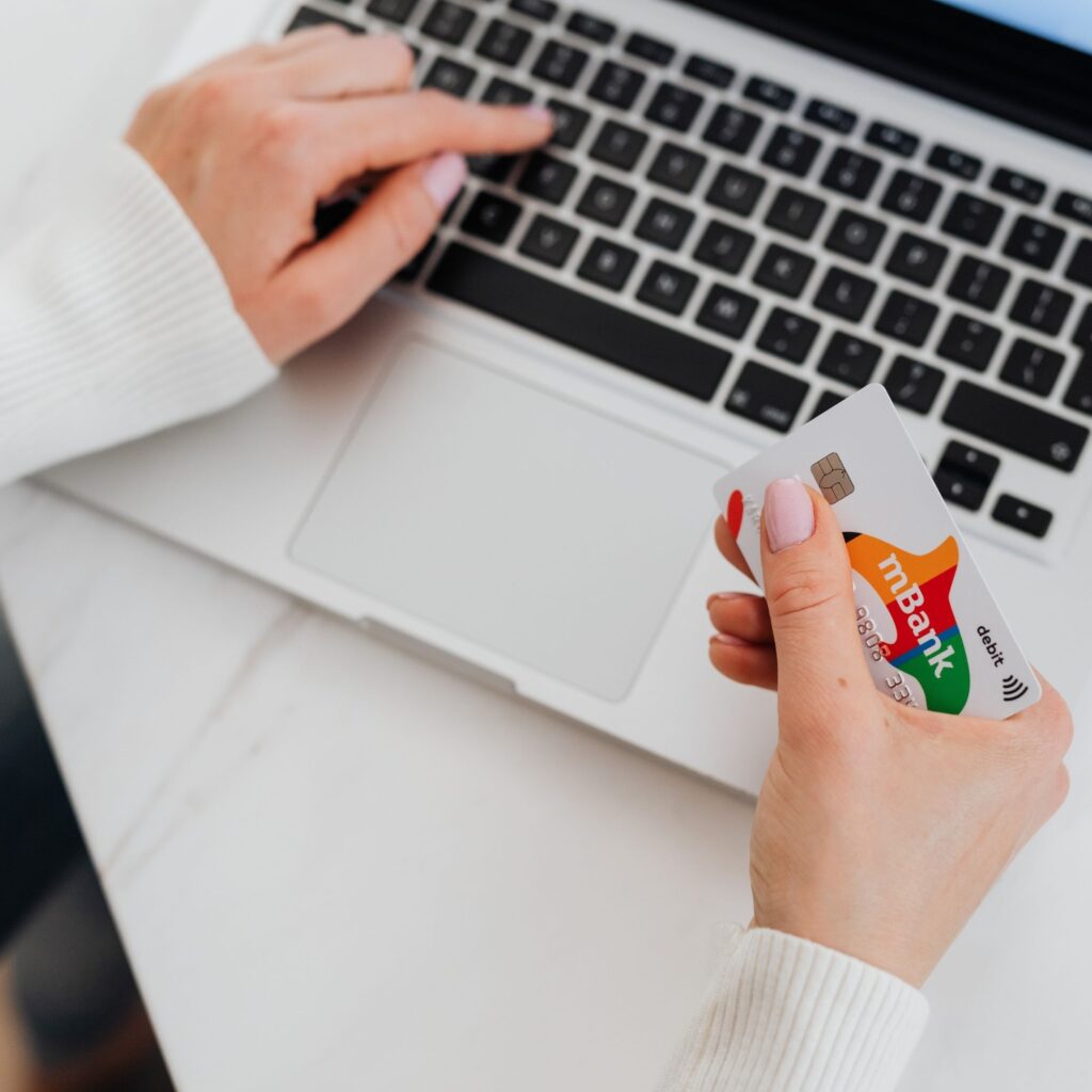 A woman on her laptop is typing in her credit card information